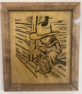 Lil’ Cowboy on porch – framed