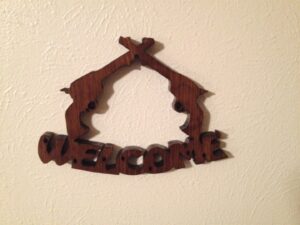 “Welcome” pistols sign